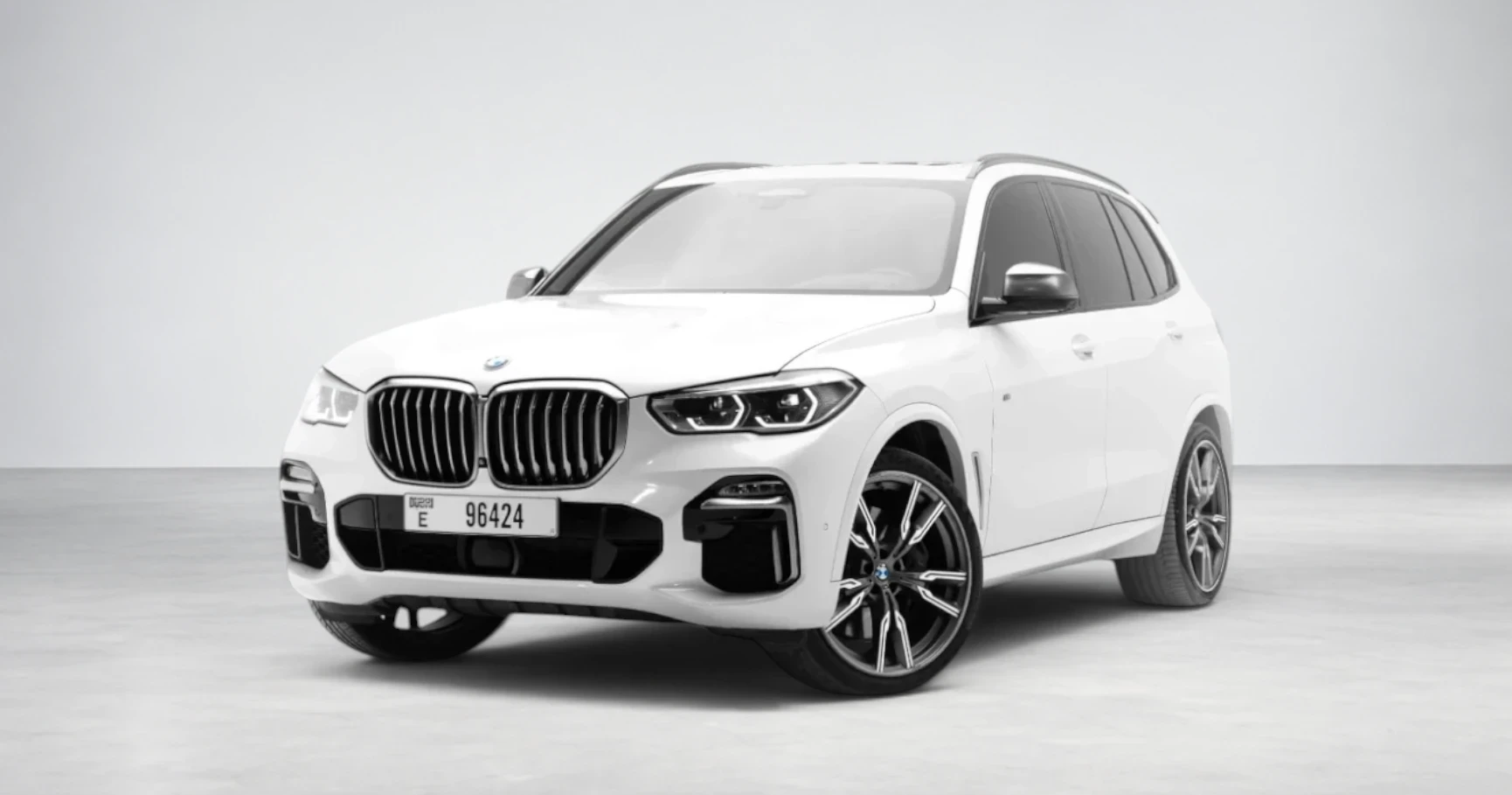 BMW X5 M50i — Mineral White luxury rental Dubai